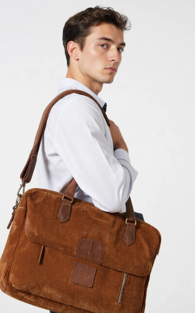 A French male model with a Corduroy   finished laptop bag, wearing a shirt, against a white background, in a front   facing close   up